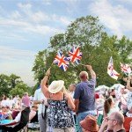 Battle Proms crowd with flags and Spitfire